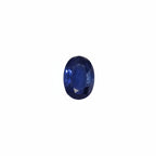 Blue gemstone in a wooden box with white interior